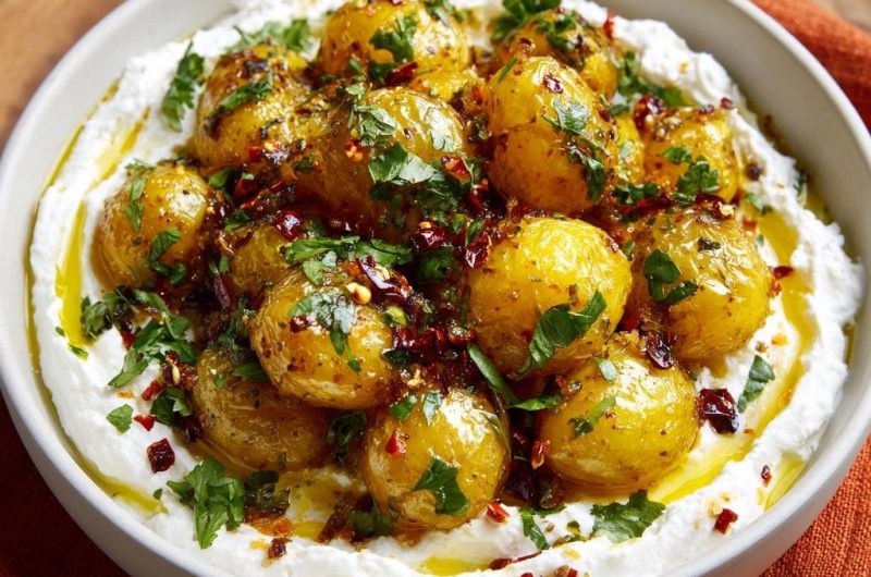 Gewürzte Babykartoffeln auf cremigem Joghurt